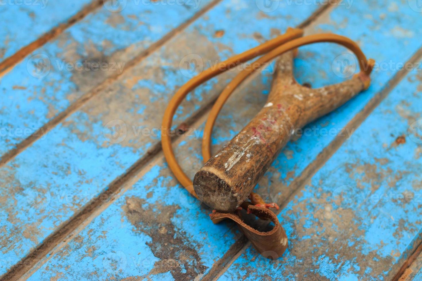 Slingshot on old blue wood photo