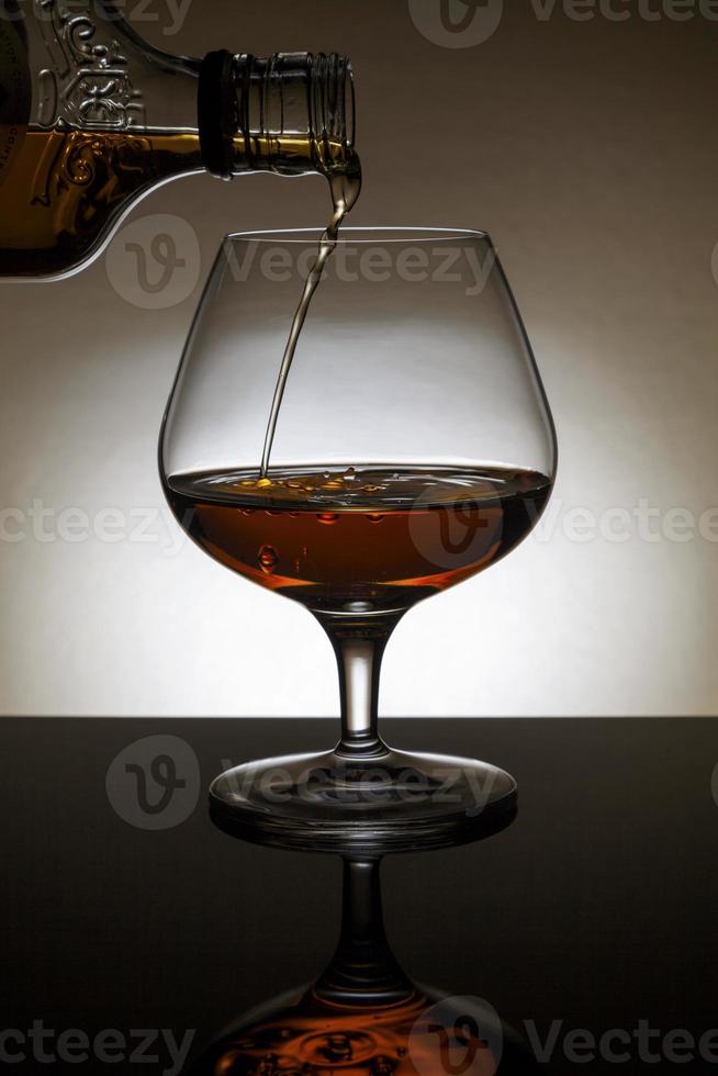 Cognac in a back-lite glass photo