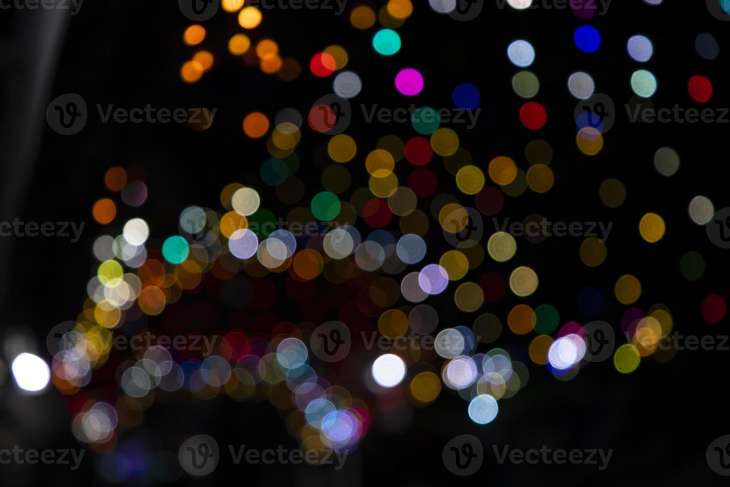 Colorful Defocus Abstract bokeh light effects on the night black background texture photo