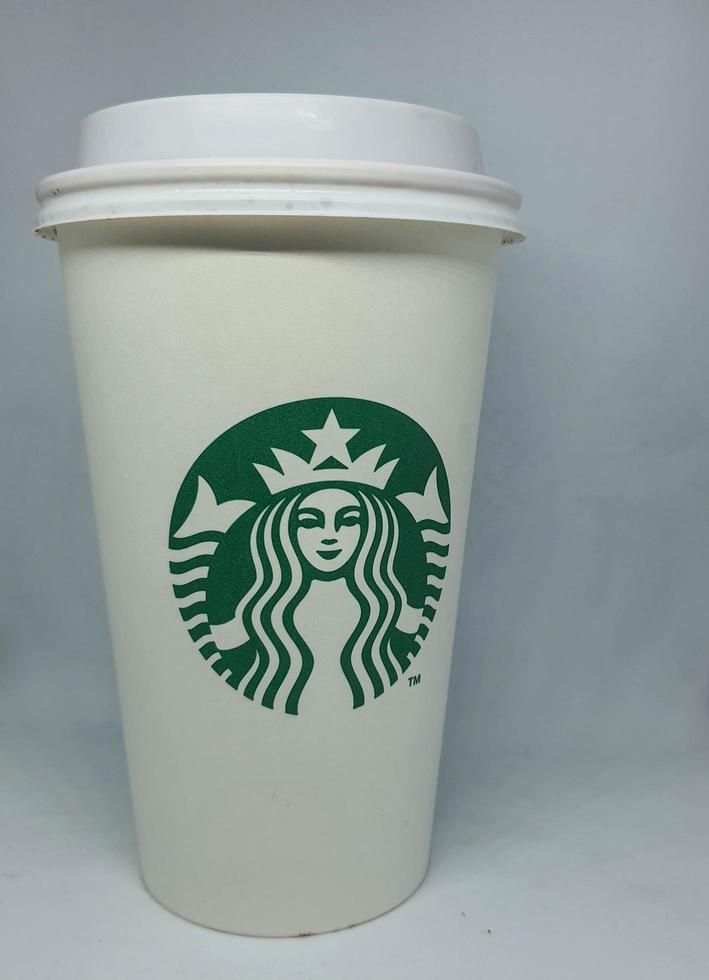 West Java, Indonesia in October 2022. A white paper cup with the starbuck logo, is used for hot drinks. photo