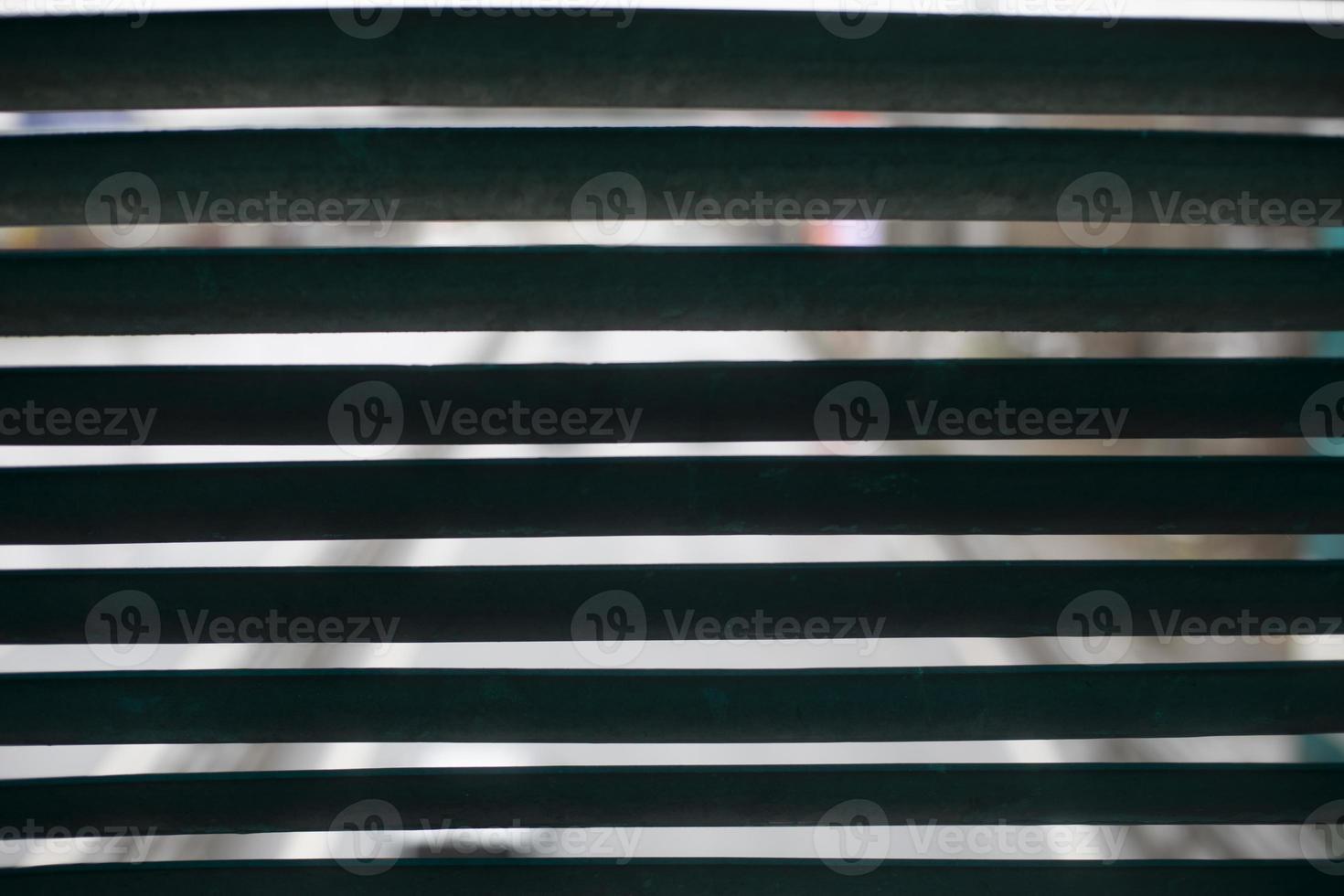 Metal grille. Blinds in building. Wall details with holes for ventilation. photo