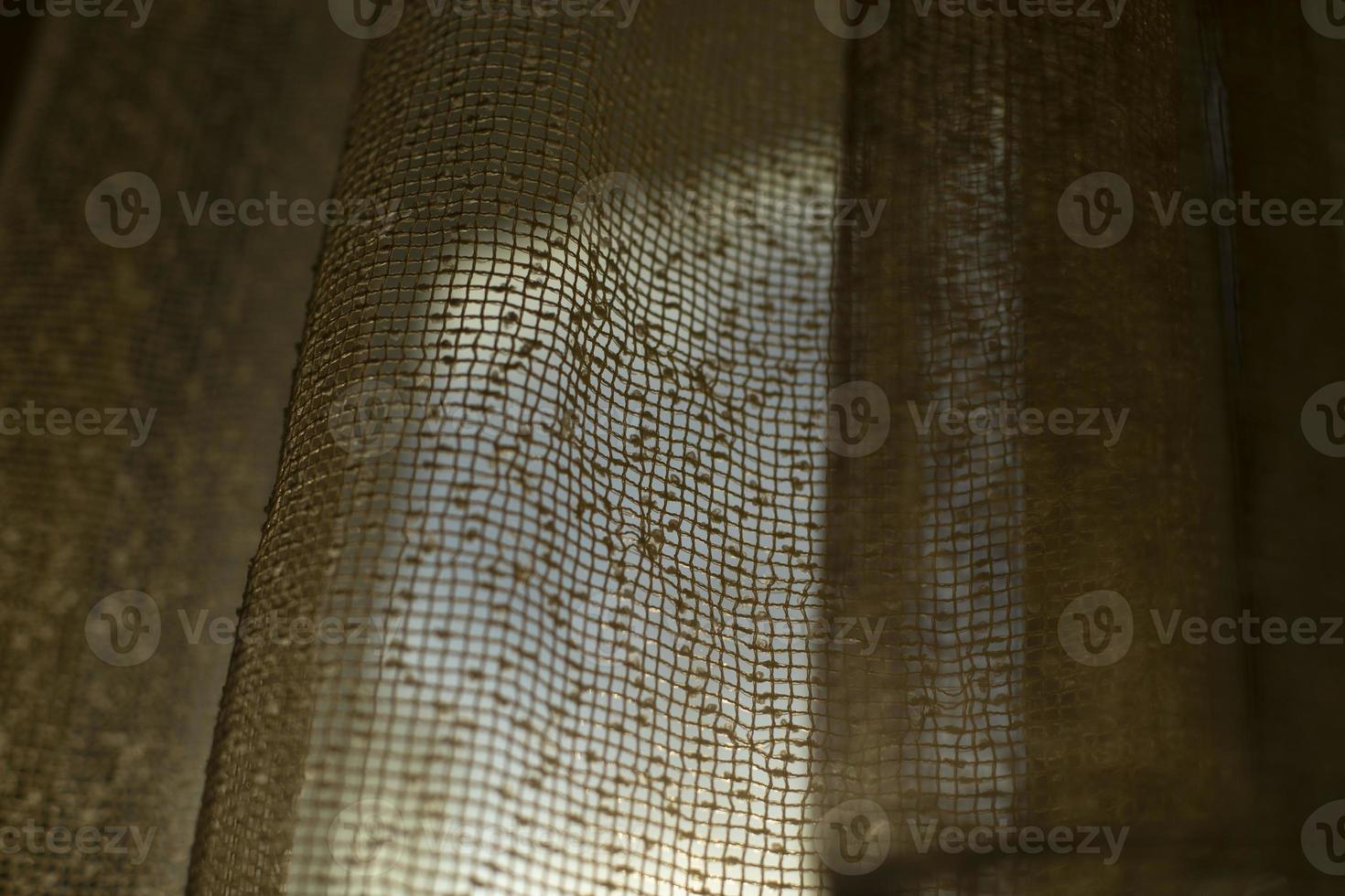 Curtains on window. Light through fabric. photo