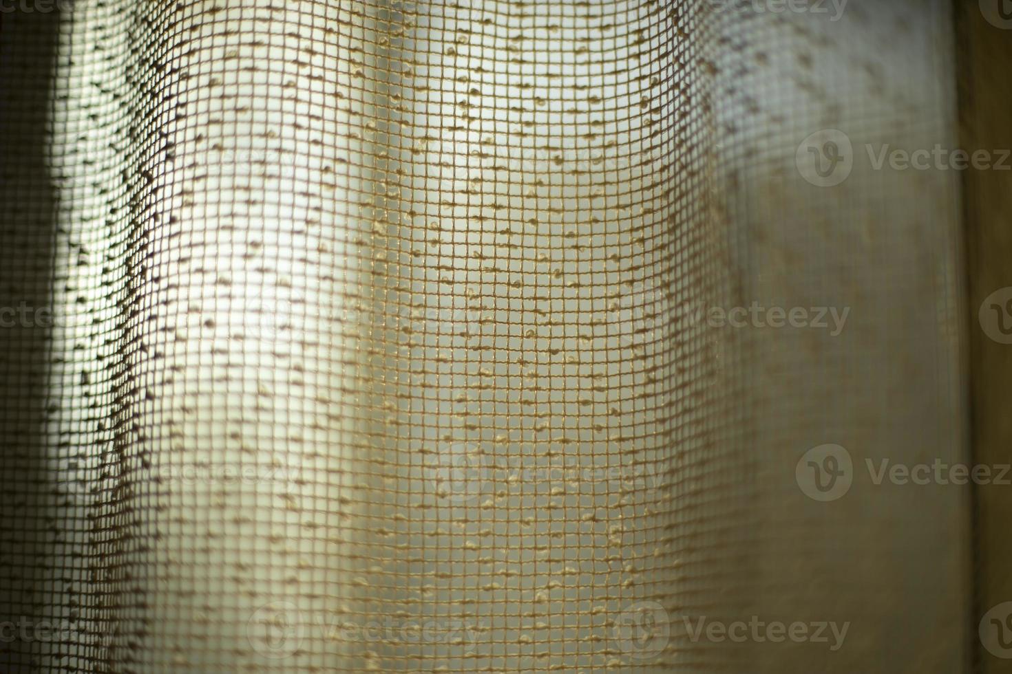 Curtains on window. Light through curtains. Fabric texture. structure of fine grid. photo