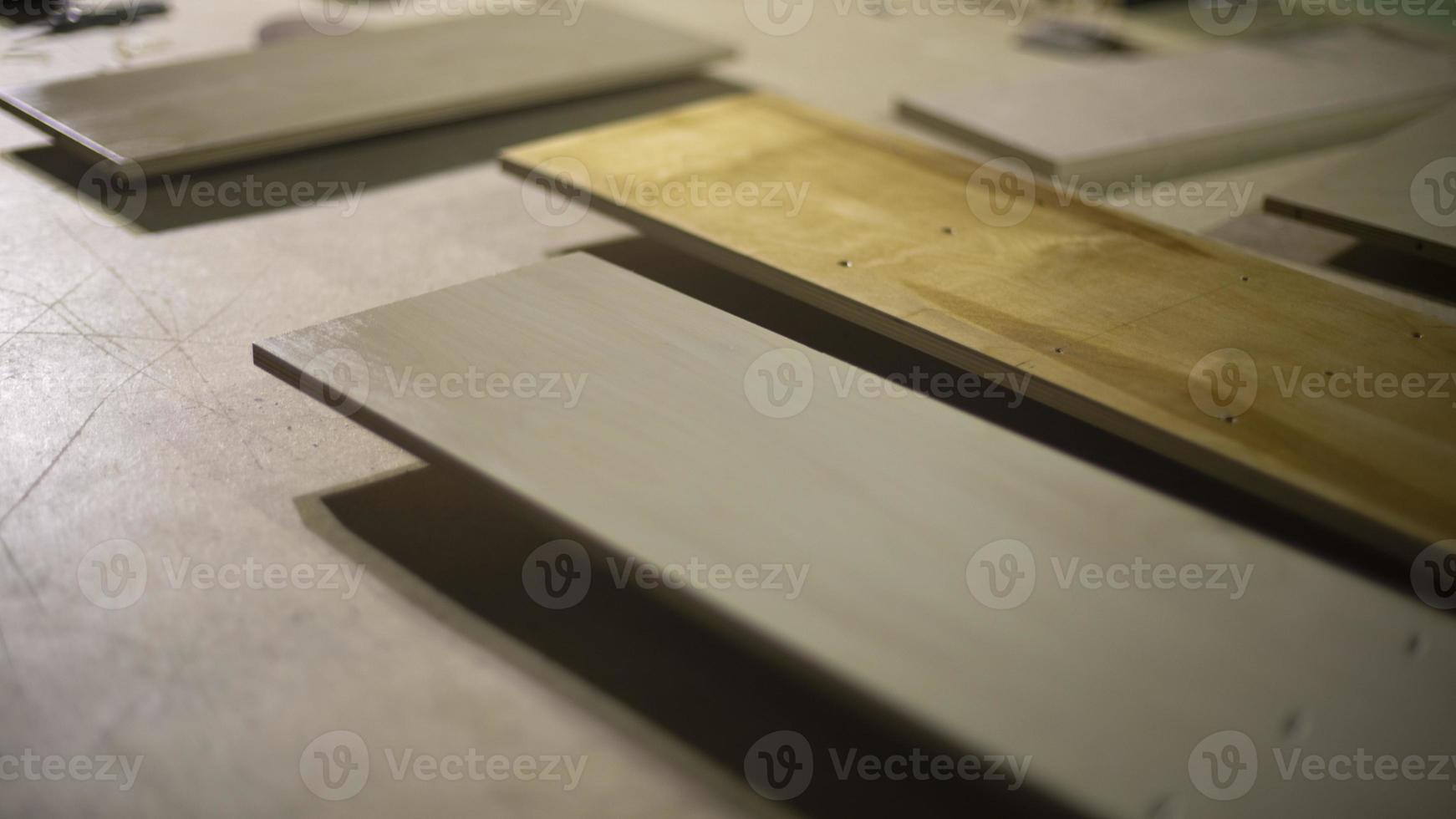 Boards are on table. Materials for creating furniture. Details of carpentry workshop. photo