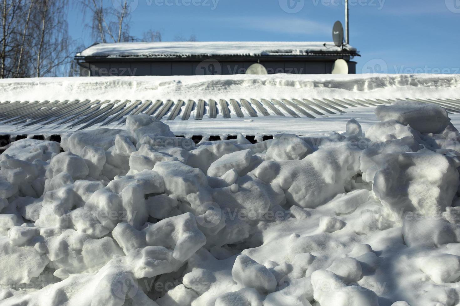 Roof with snow. Snow fell from roof of house. photo