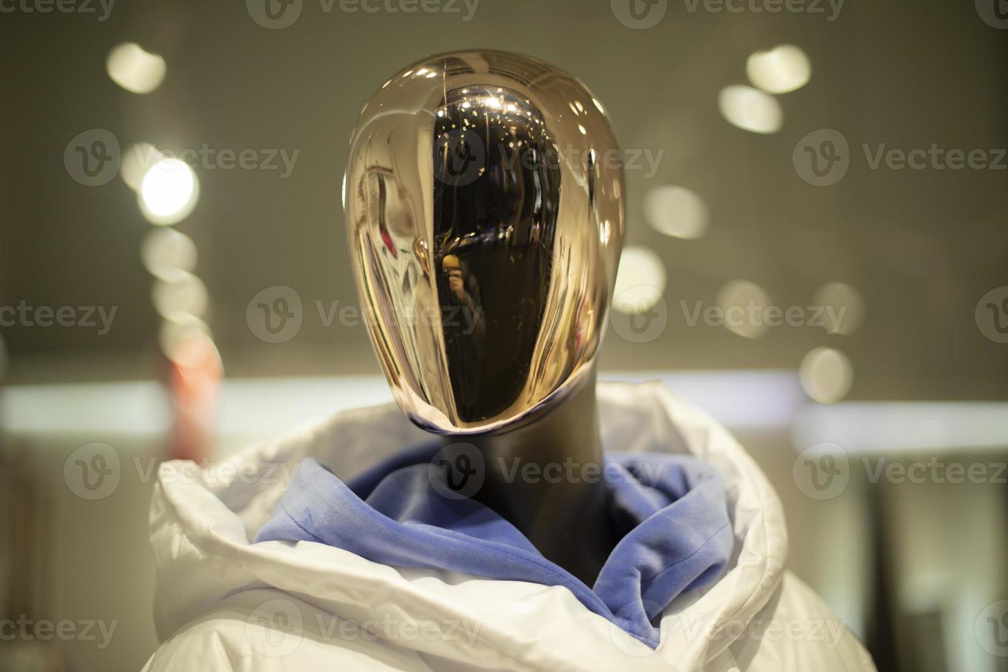 Golden mask on face of mannequin. Details of style and fashion. Mannequin in clothing store. photo