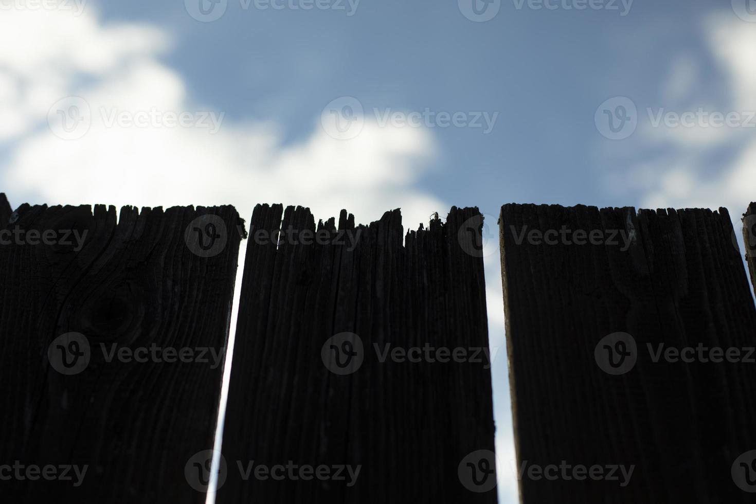 Close-up of board fence. Cracked fence board. Details of countryside. photo