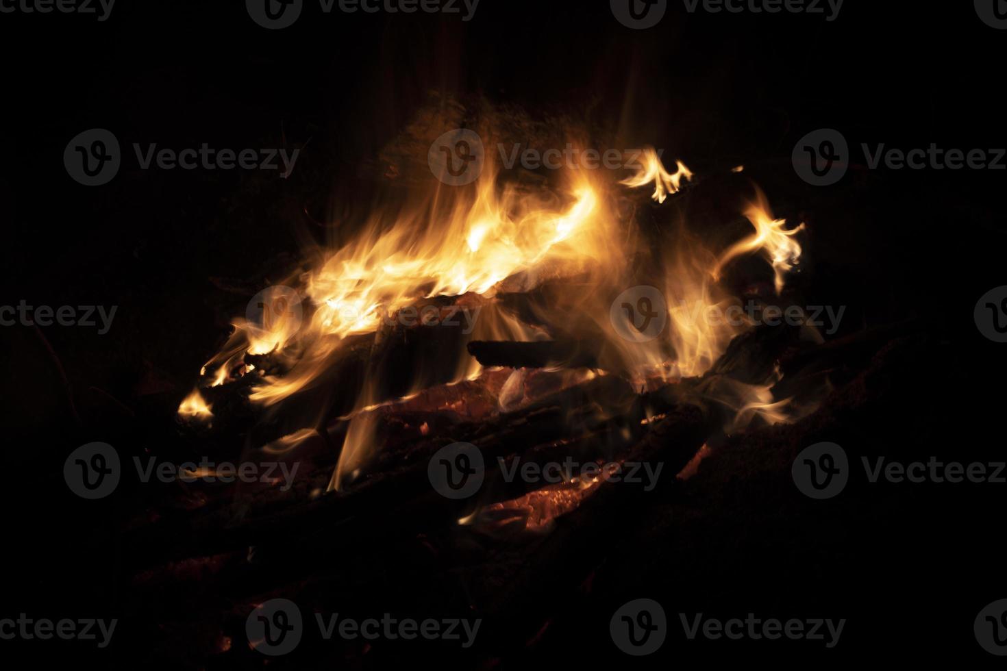 Bonfire in dark. Flames at night. Burning wood. Camping details. photo