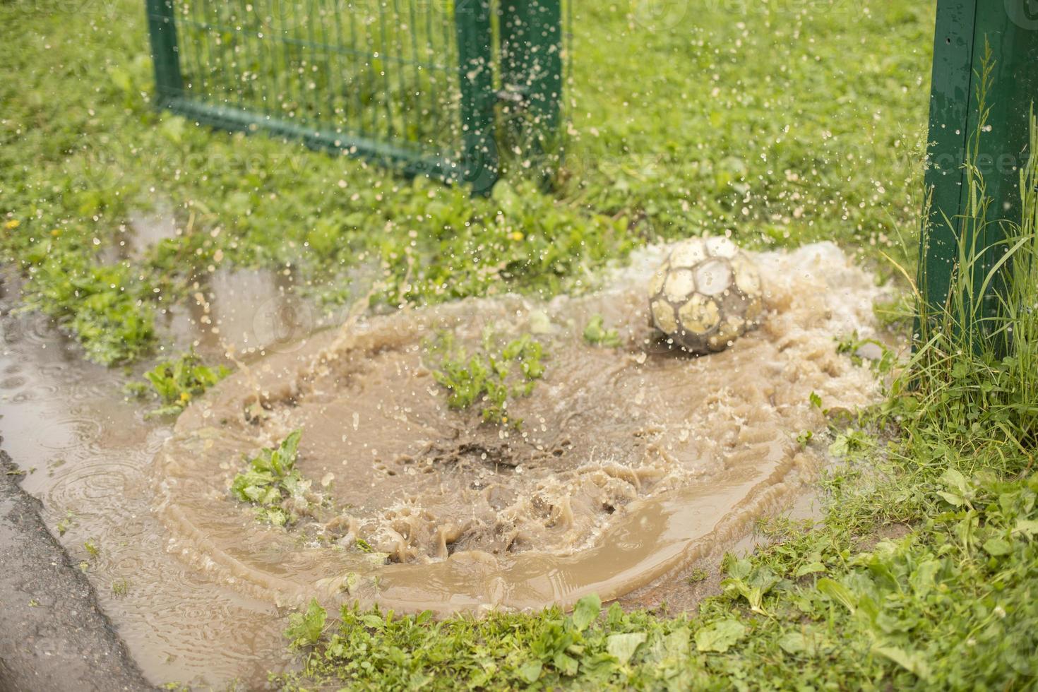 Ball in puddle. Soccer ball in water. 13056968 Stock Photo at Vecteezy