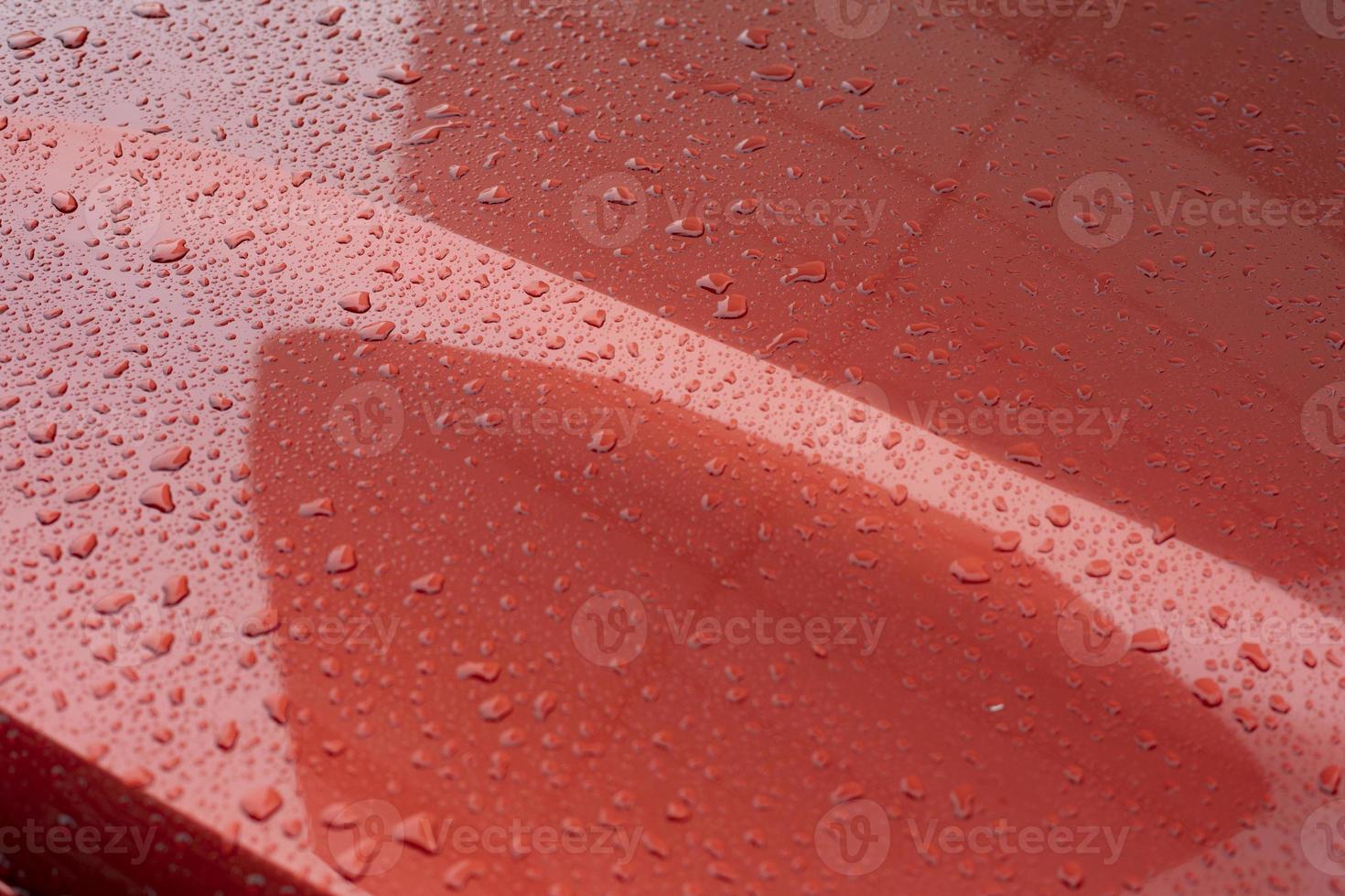 Raindrops on car. Red car is in details. photo