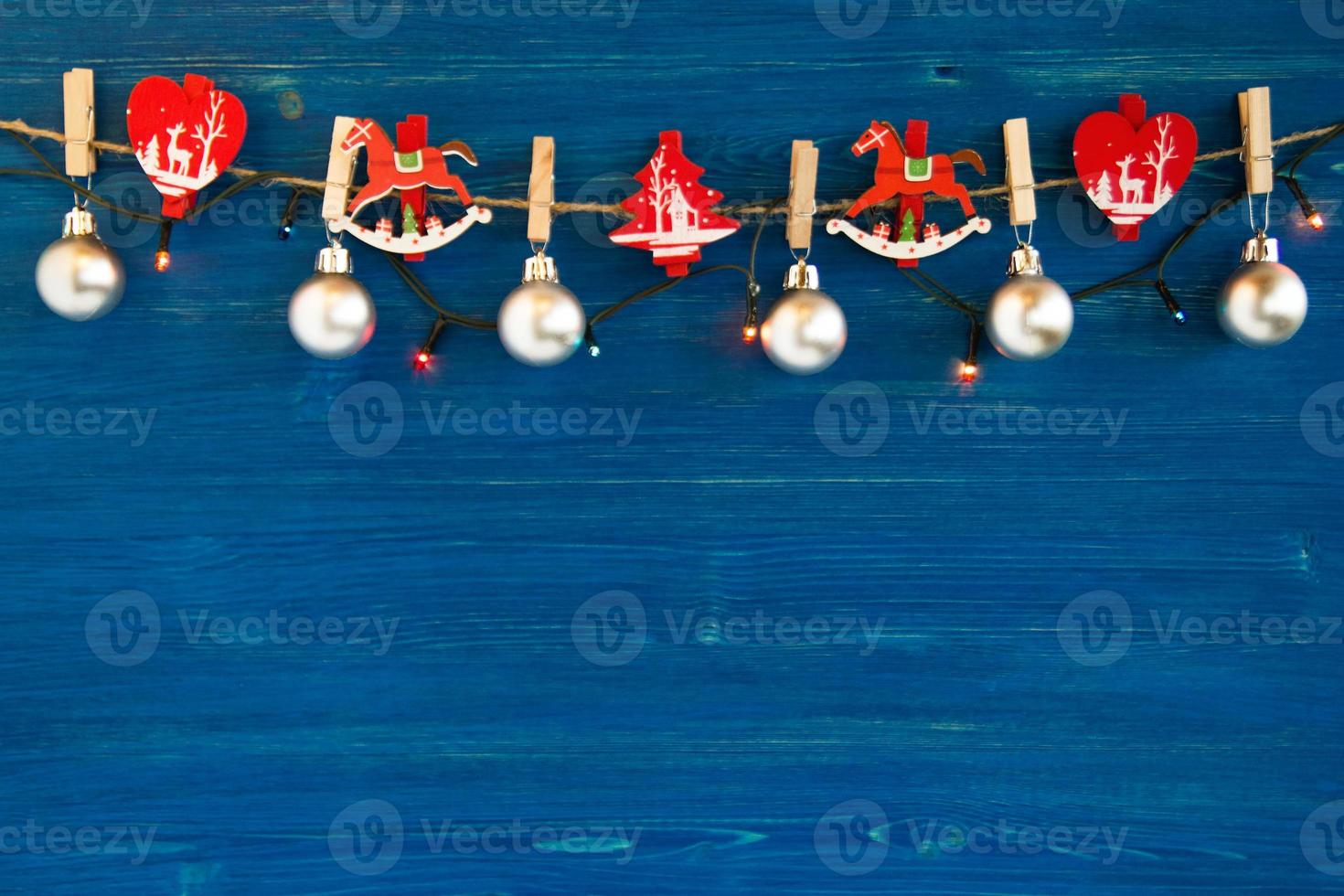 Christmas decorations and Christmas lights on the blue wooden background, top view. photo