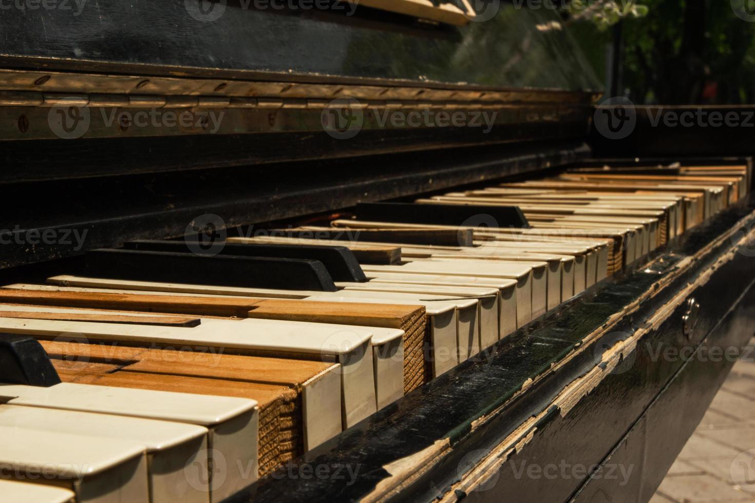 The old piano closeup on the street. photo