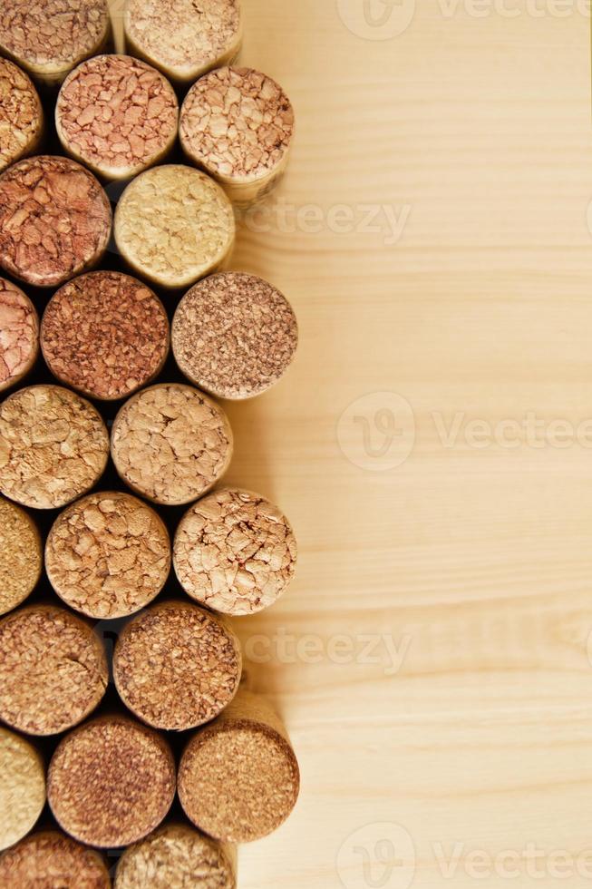 A lot of wine textured wine cork on the wooden background. photo