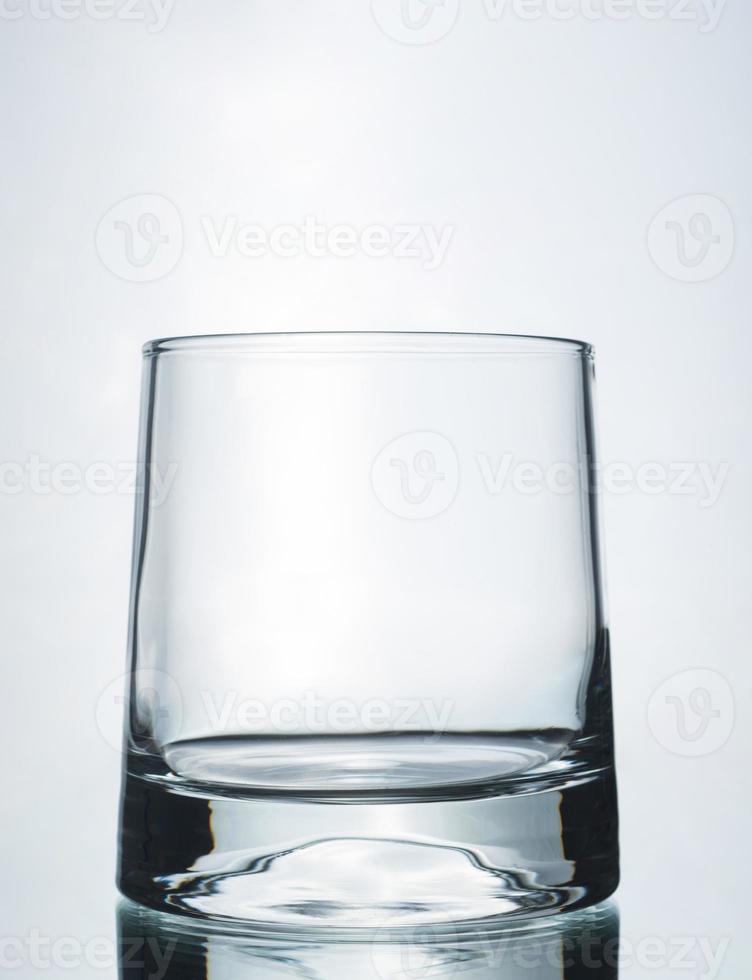 A vertical shot of an empty glass on a grey background photo