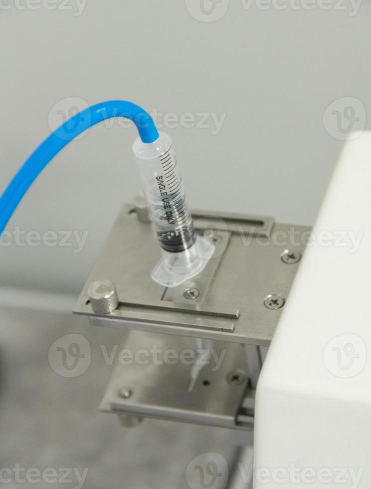 A closeup of the production and testing of medical syringes and droppers photo
