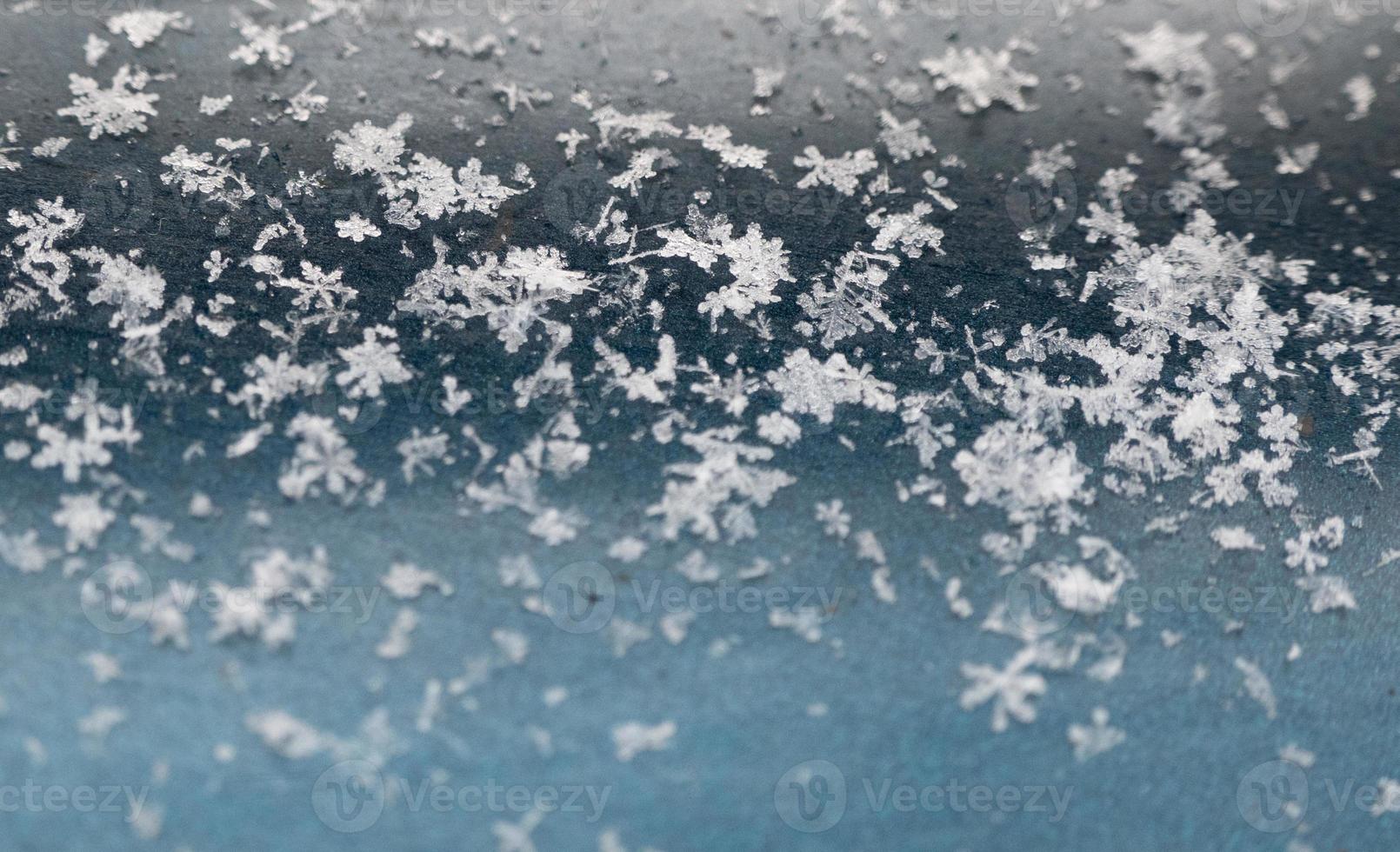 snowflakes on a blue background. closeup snow texture, natural Christmas bacground photo