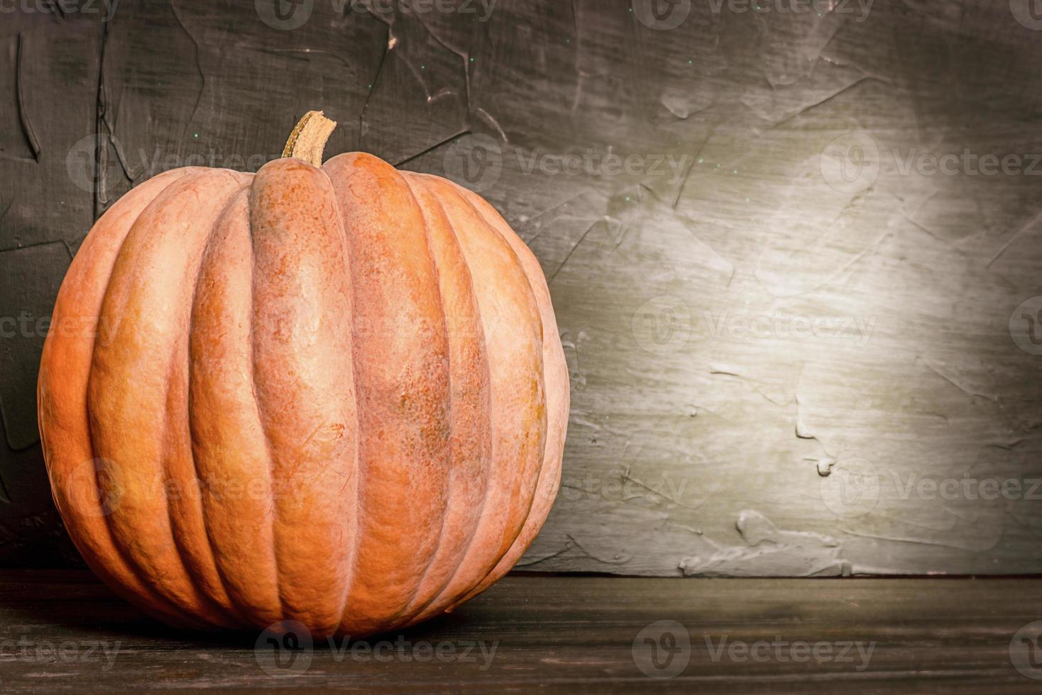 Orange pumpkin on a dark background. Harvest, Halloween. photo