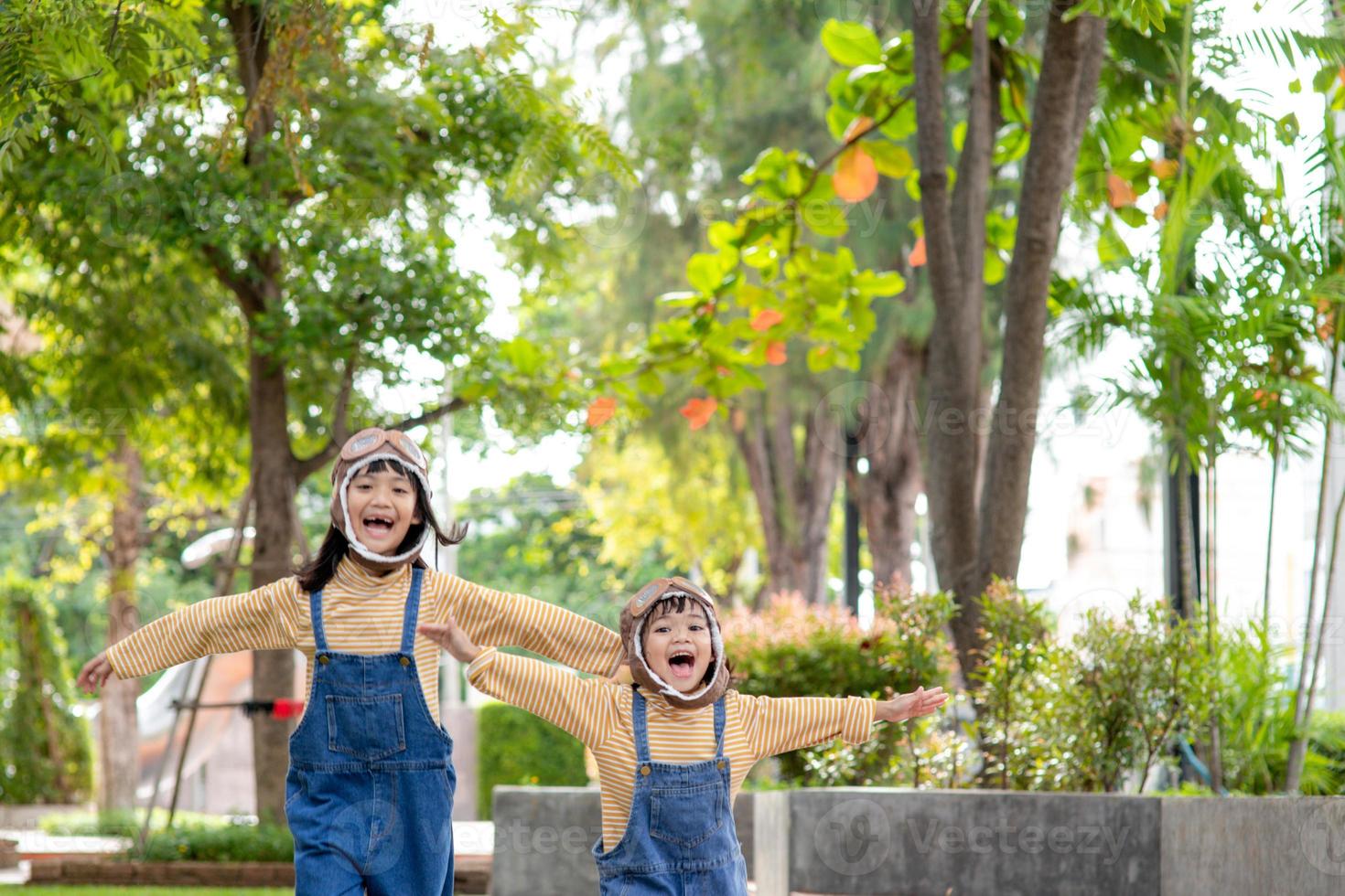 A cute little girl dressed in a cap and glasses of a pilot. The child dreams of becoming a pilot. photo