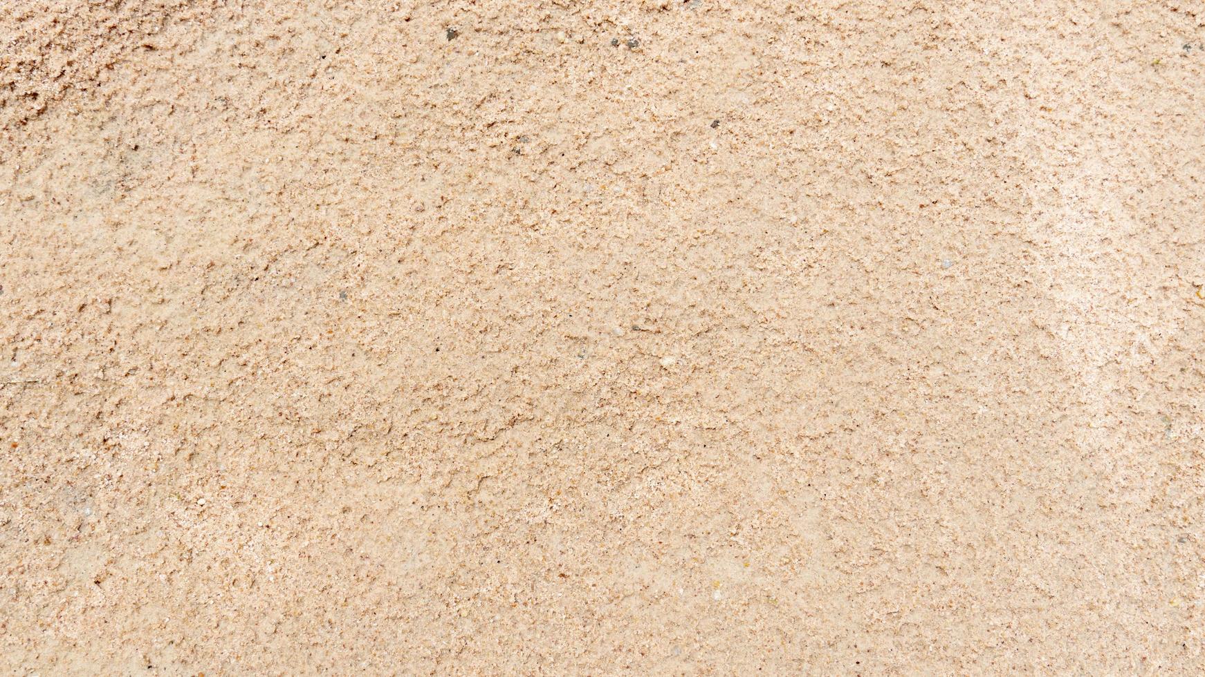 Backgorund and textured of finely compacted sand surface. photo