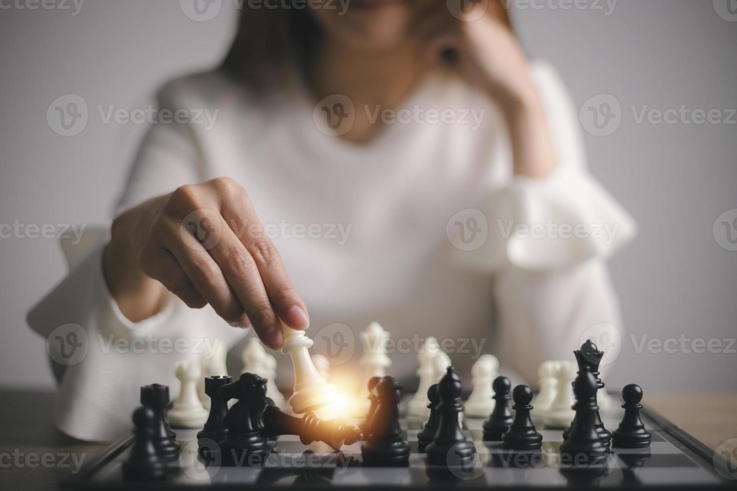 Businesswoman plays with chess game. concept of business strategy and tactic. strategy, management, or leadership concept photo