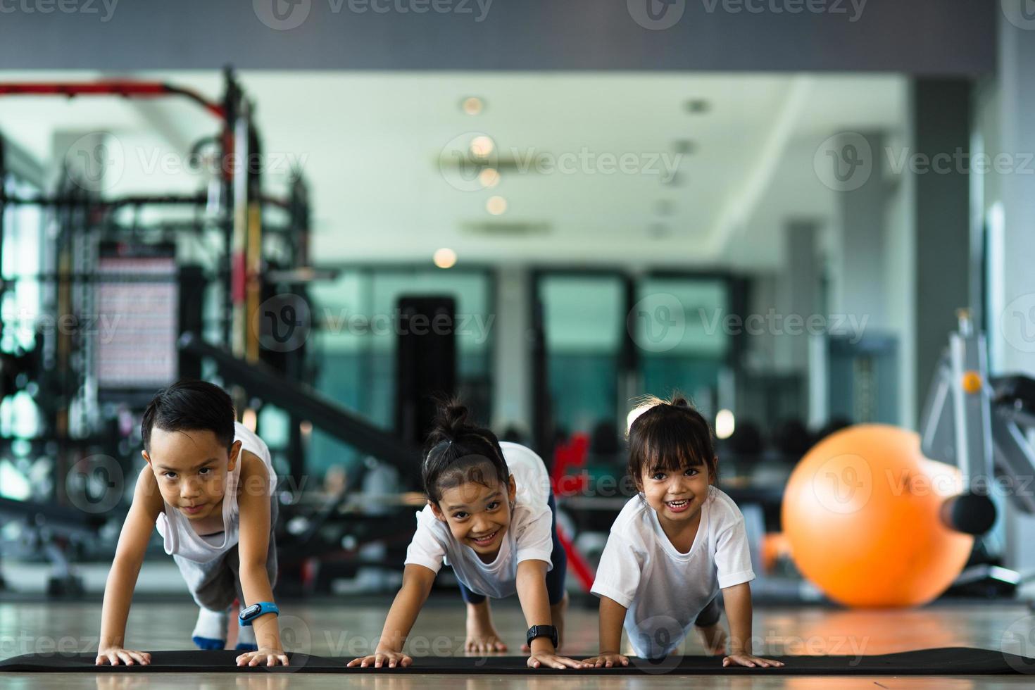 Group of children doing gymnastic exercises photo