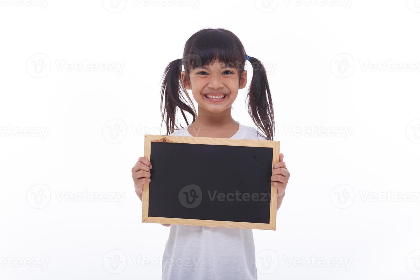 little Asian child show the black board on isolated background photo