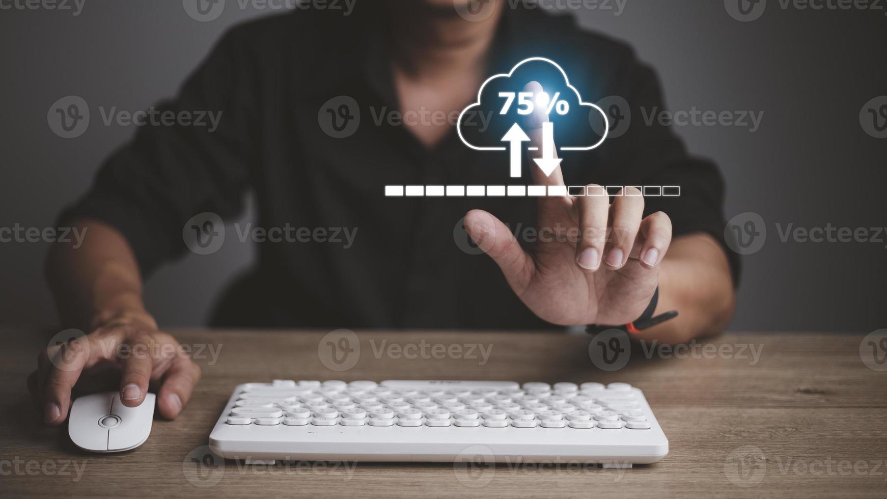 Man doing cloud uploading or downloading on laptop computer at office photo