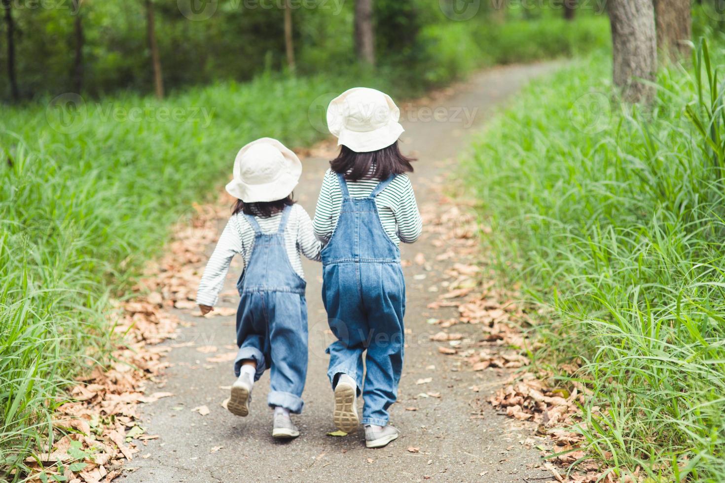 Children are heading to the family campsite in the forest walk along the tourist route. camping road. family travel vacation concept. photo