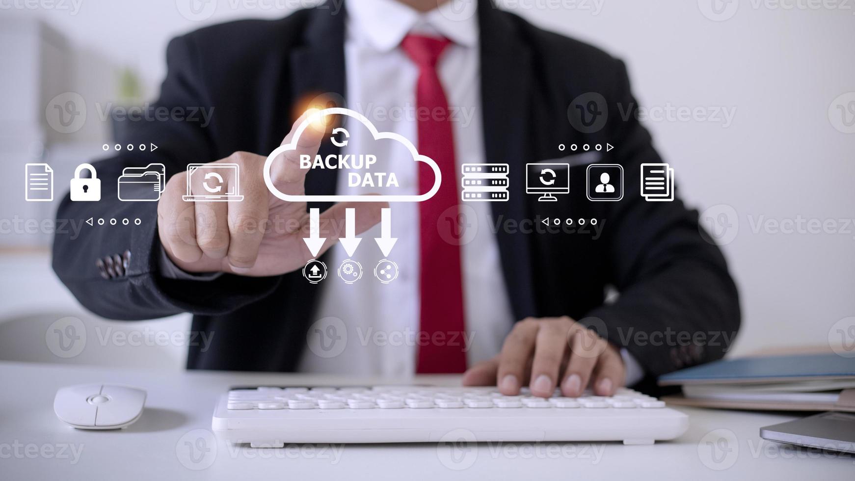 Businessman using a computer to backup storage data Internet technology concept for backup online documentation database and digital file storage system or software,file access, doc sharing. photo