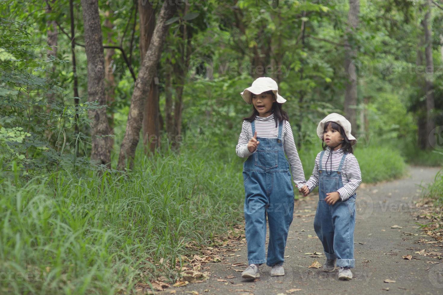 Children are heading to the family campsite in the forest Walk along the tourist route. Camping road. Family travel vacation concept. photo