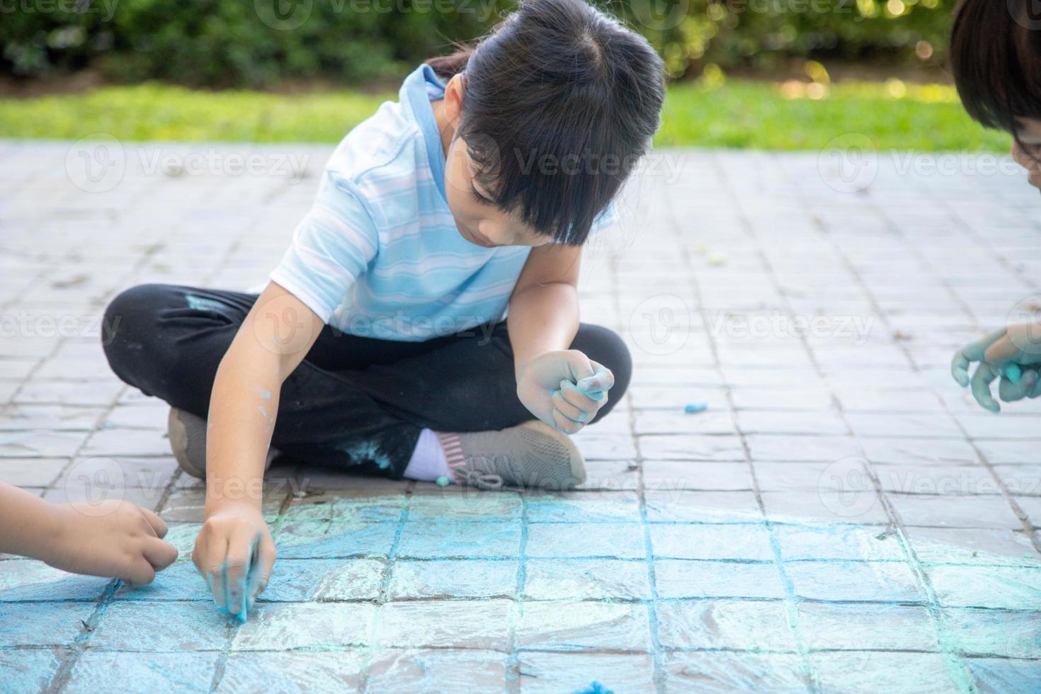Children playing with colored chalks photo