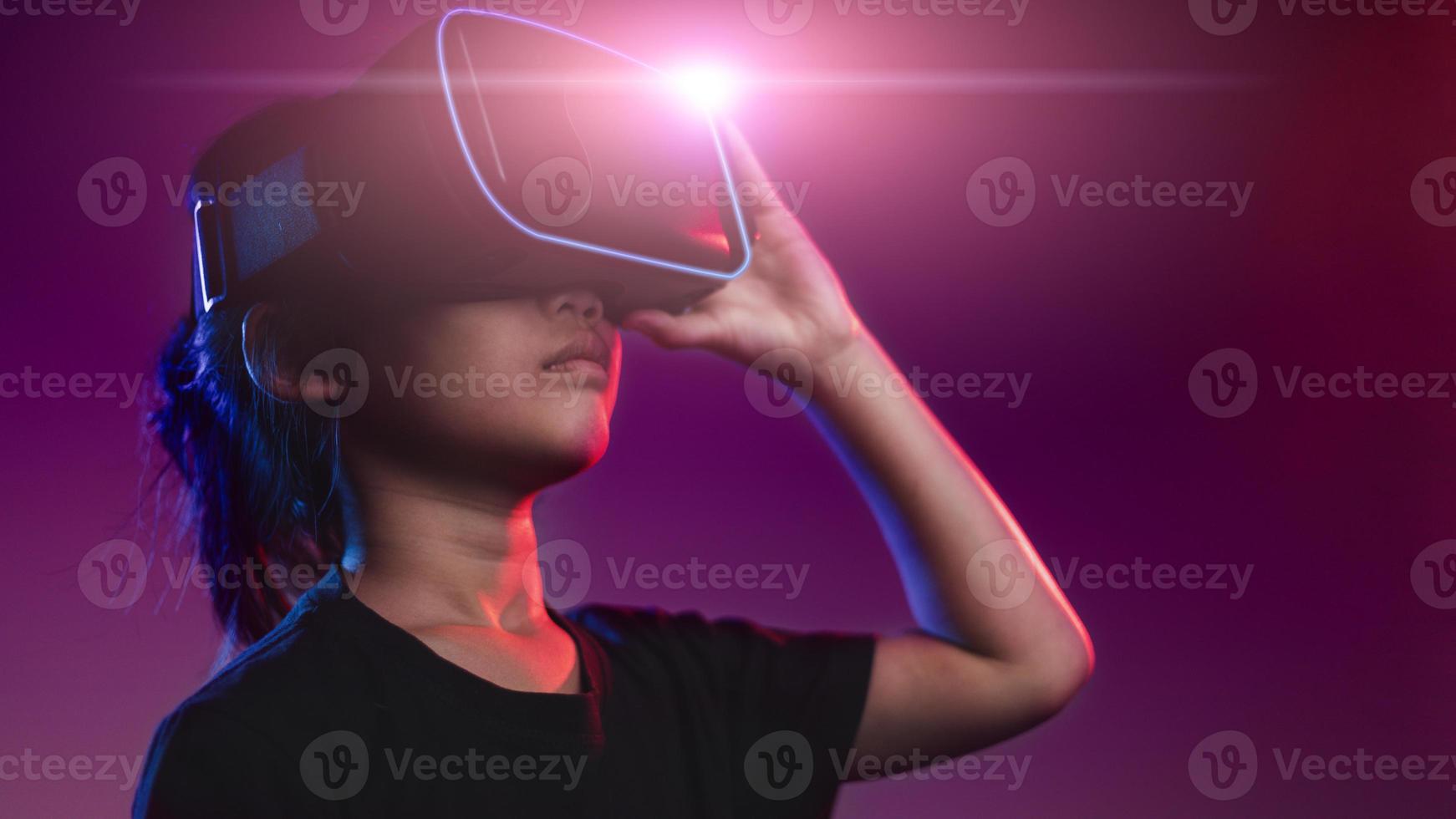 happy girl in glasses of virtual reality. Augmented reality, science, future technology concept. VR. Futuristic 3d glasses with virtual projection. Neon light. photo
