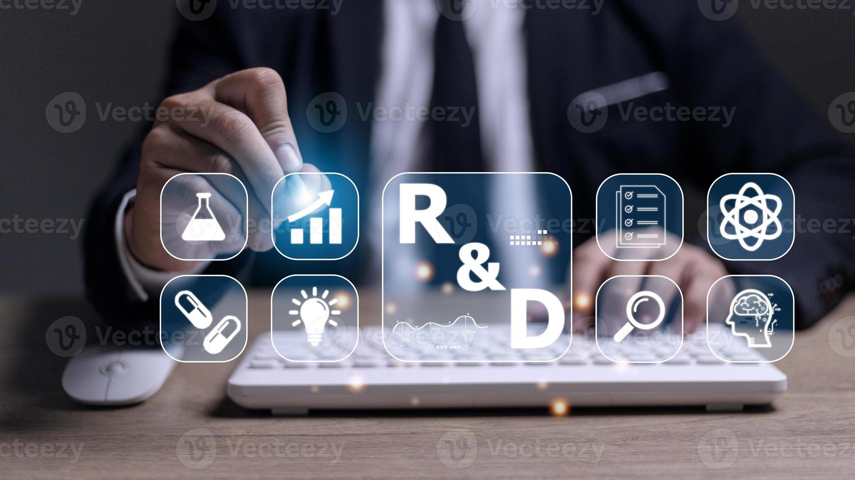 Hand of businessman holding a pen pointing to R and D icon for Research and Development on laptop screen. Manage costs more efficiently. R and D innovation concept. photo