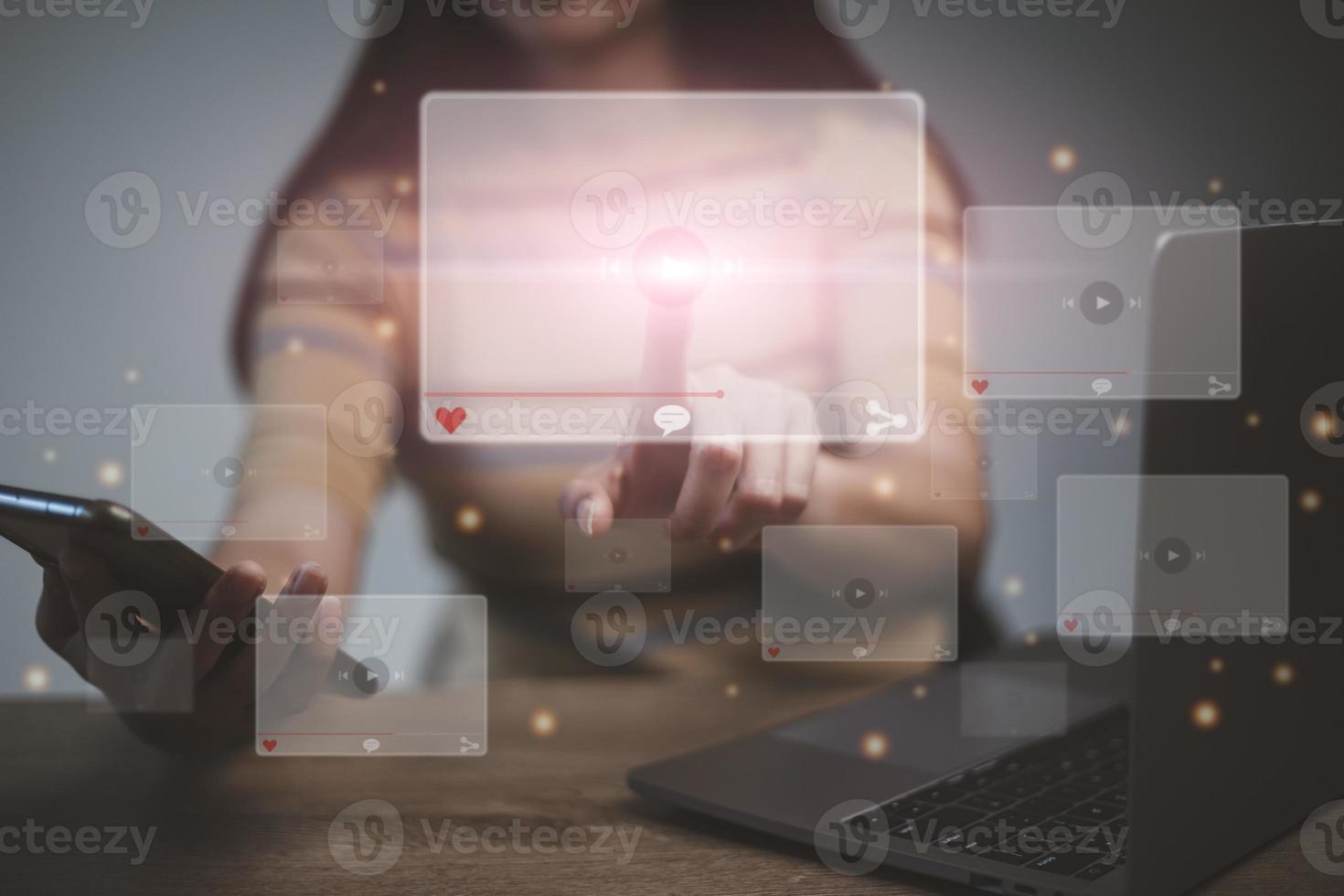 hands of women using laptop and smartphone for streaming online, watching video on internet, live concert, show or tutorial photo