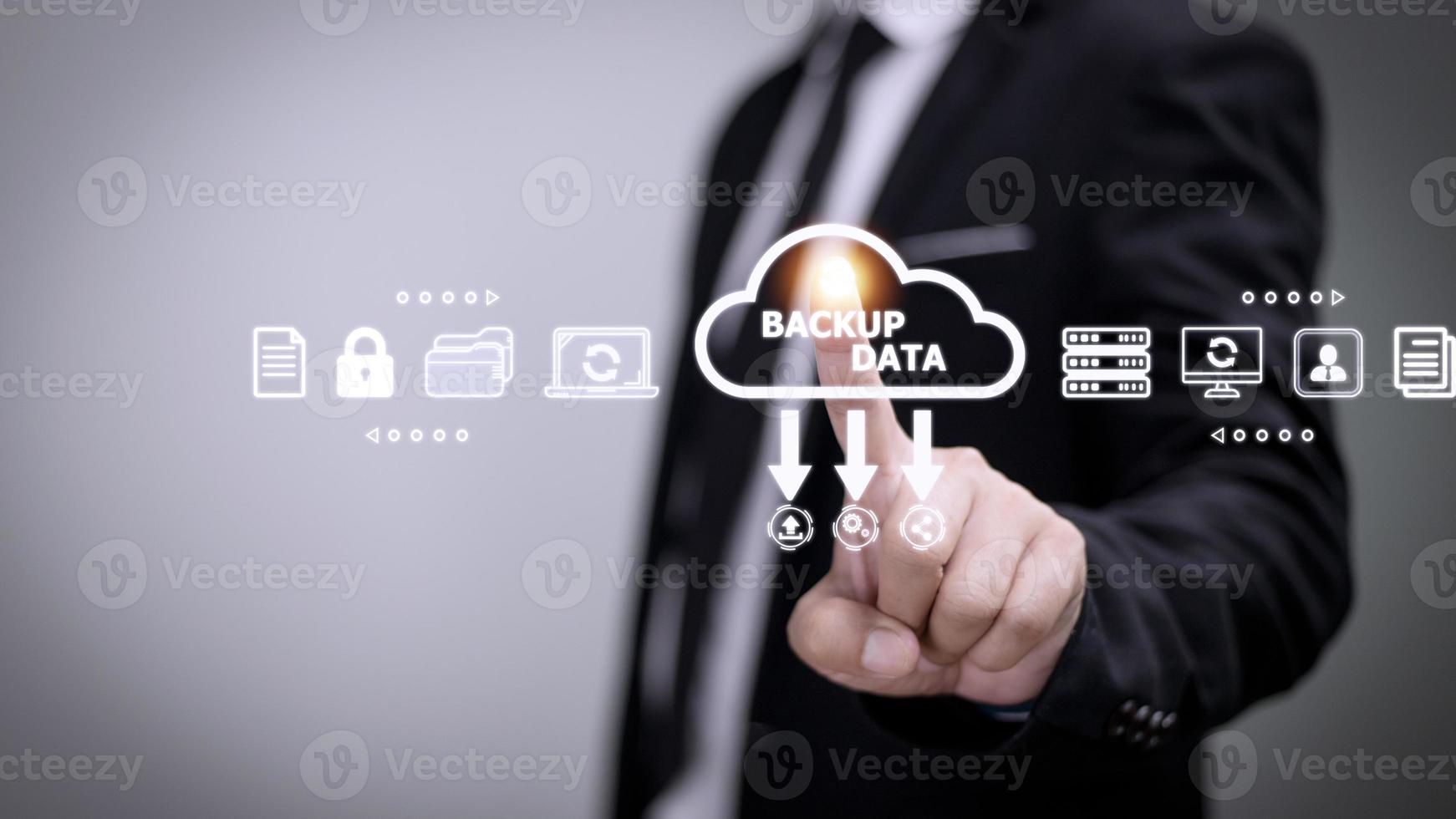 Businessman using a computer to backup storage data Internet technology concept for backup online documentation database and digital file storage system or software,file access, doc sharing. photo