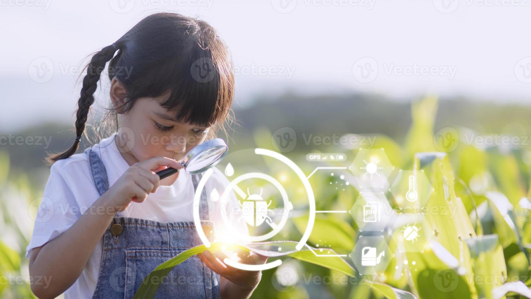 The little girl uses a tablet to analyze the growth of plants in the agricultural plot and visual icon., the agricultural technology concept. smart farming learning Concept photo