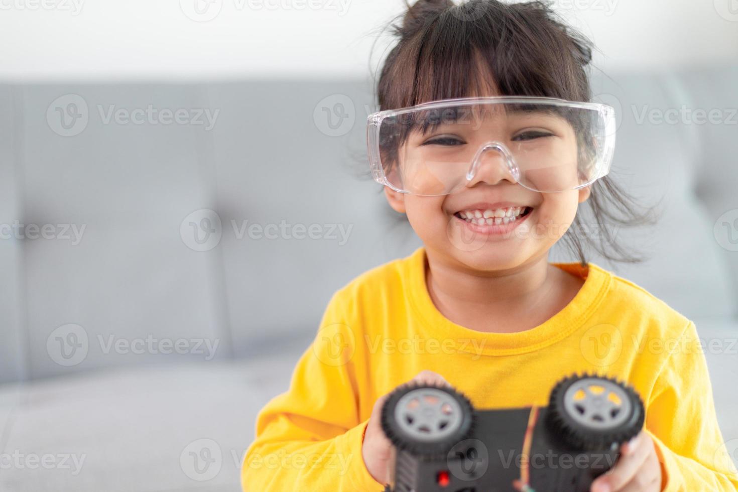 Inventive kid constructing robot cars at home photo