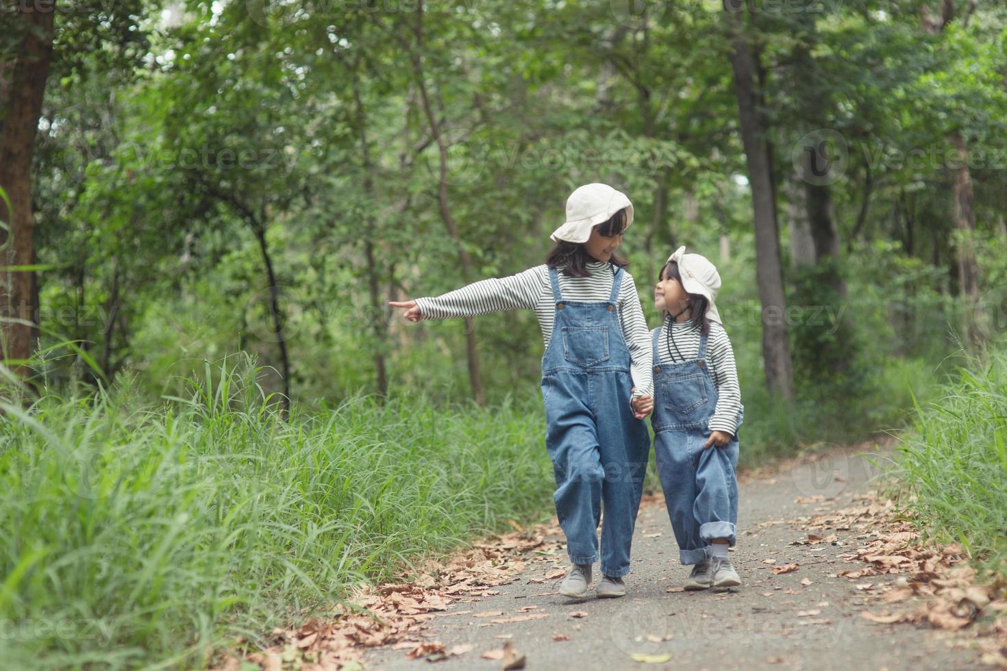 Children are heading to the family campsite in the forest Walk along the tourist route. Camping road. Family travel vacation concept. photo