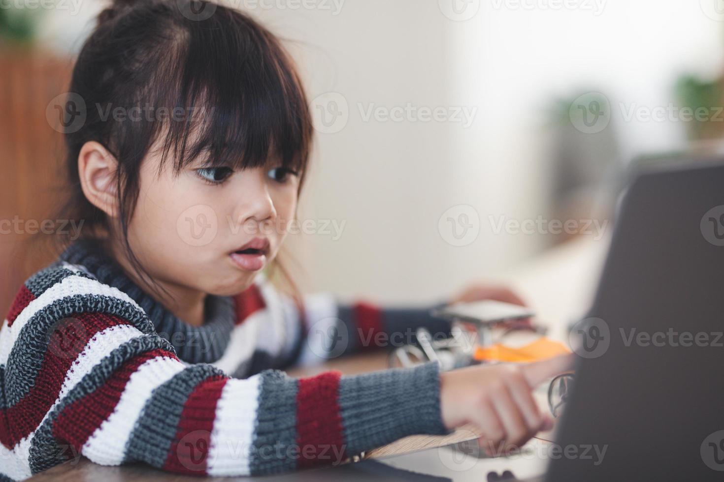 Inventive kid constructing robot cars at home photo
