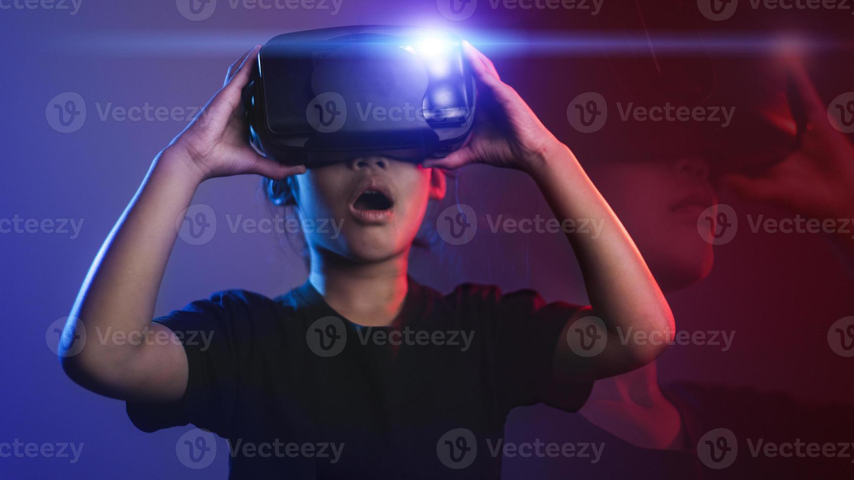happy girl in glasses of virtual reality. Augmented reality, science, future technology concept. VR. Futuristic 3d glasses with virtual projection. Neon light. photo