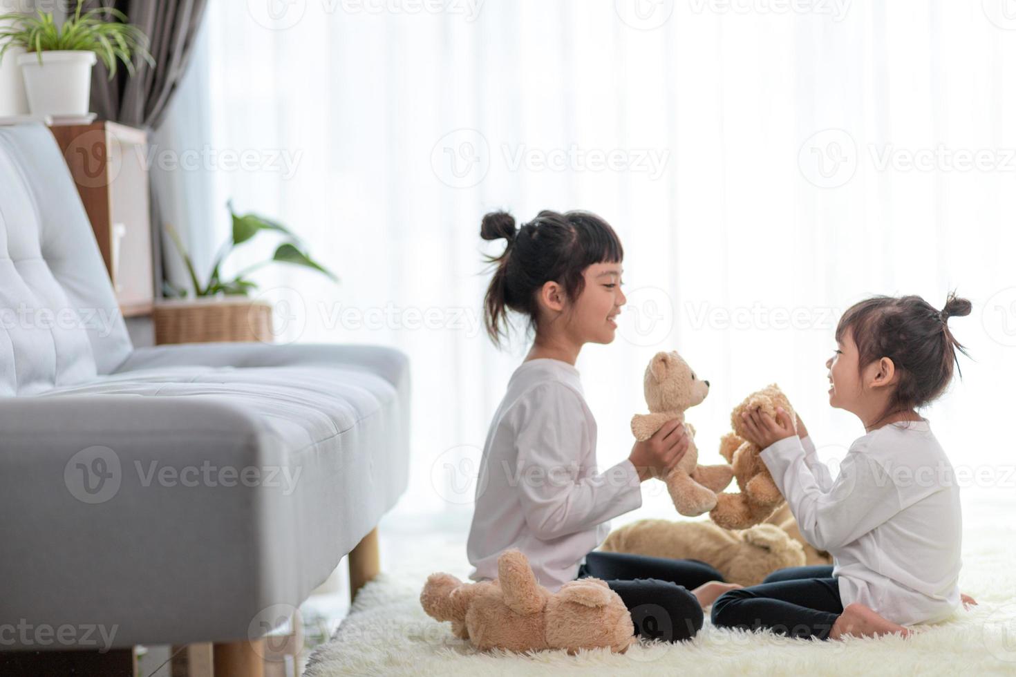 Cute funny children playing with teddy bear at home photo