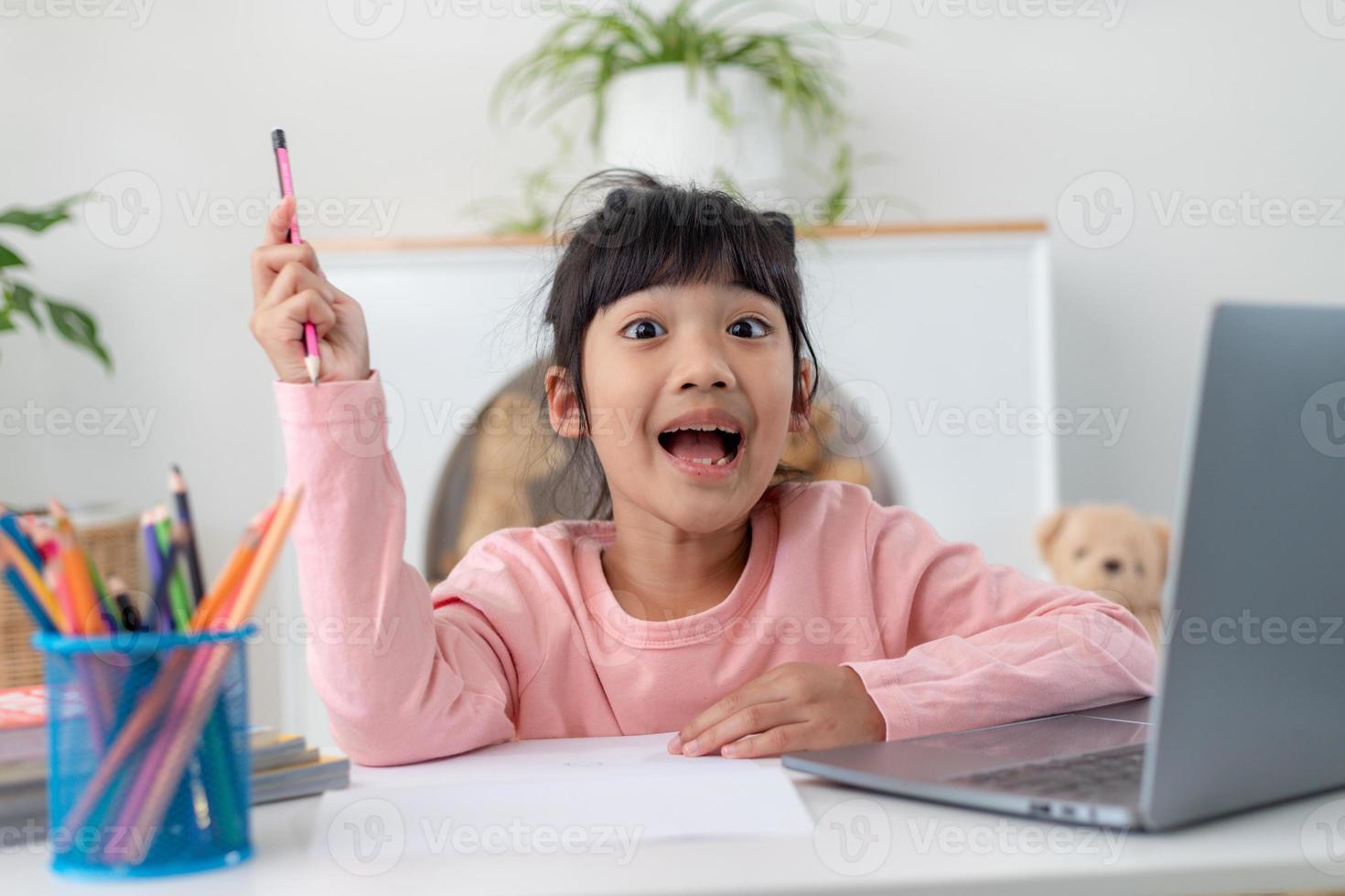 Asian girl using Laptop computer for online study homeschooling during home quarantine. homeschooling, online study, home quarantine, online learning, corona virus or education technology concept photo