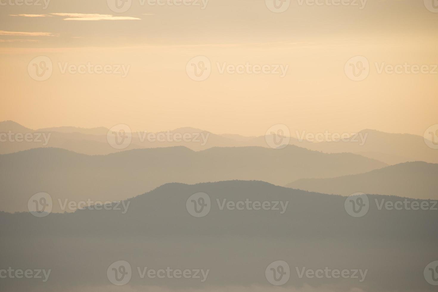 Layer of mountains and mist during sunset photo