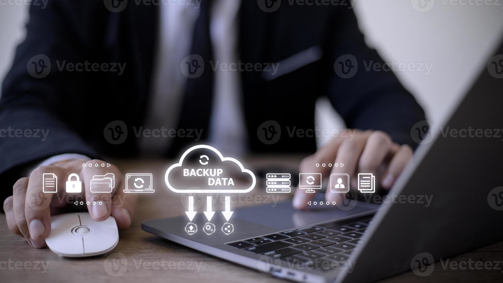 Businessman using a computer to backup storage data Internet technology concept for backup online documentation database and digital file storage system or software,file access, doc sharing. photo
