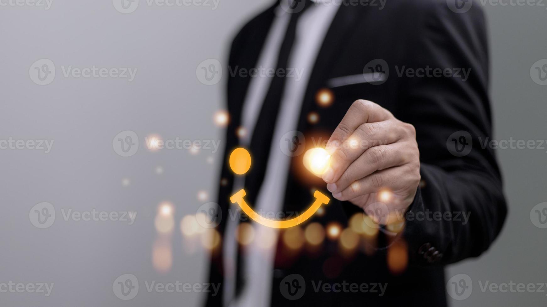 The consumer answered the survey in a conceptual way. Customer creates a happy face smiling symbol using a digital pen. The notion of customer happiness and service experience. photo
