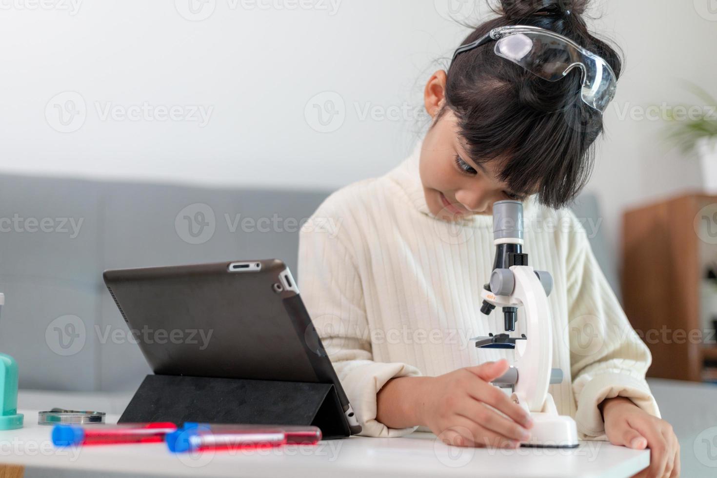 young girl play science experiments for homeschooling photo