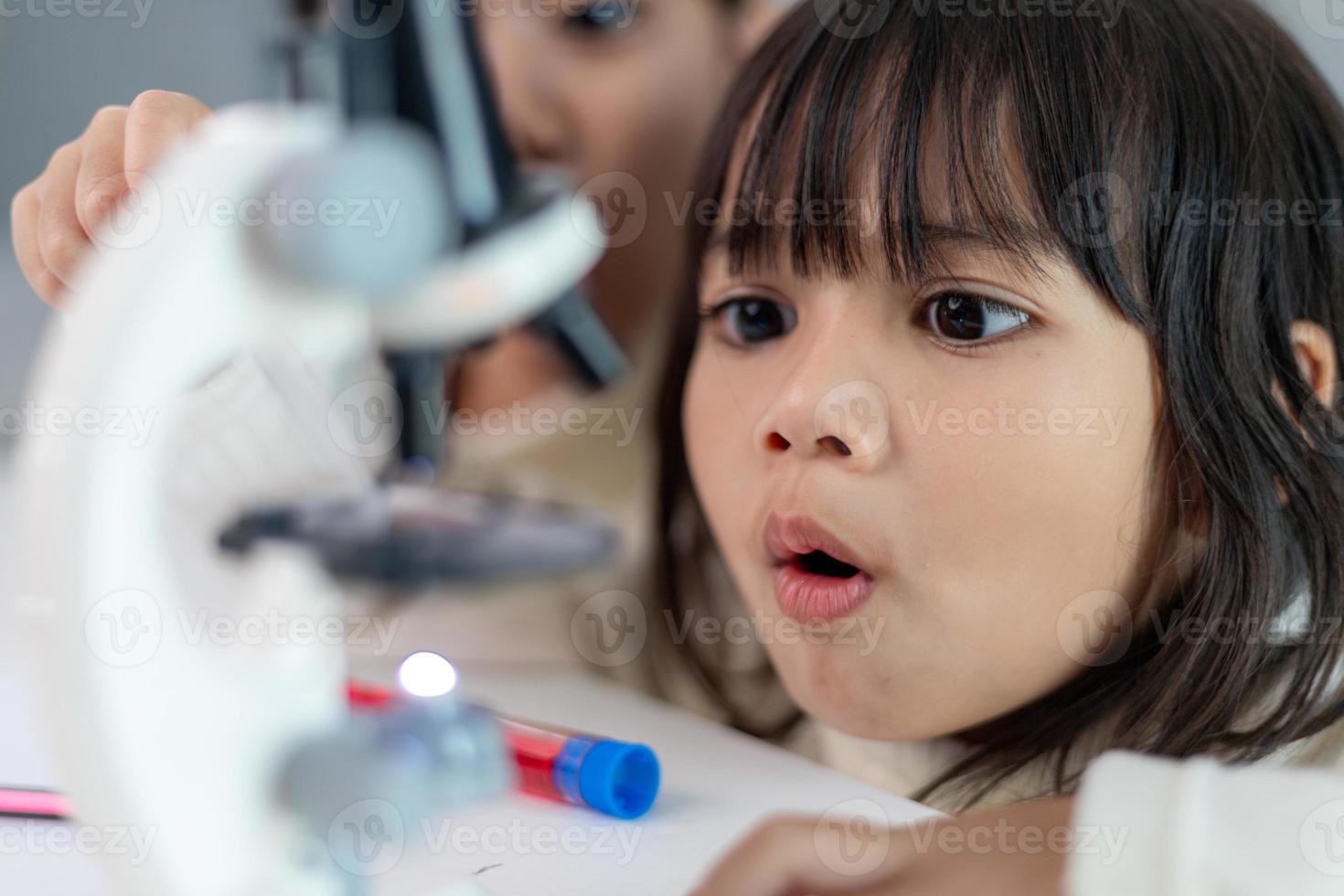 young girl play science experiments for homeschooling photo