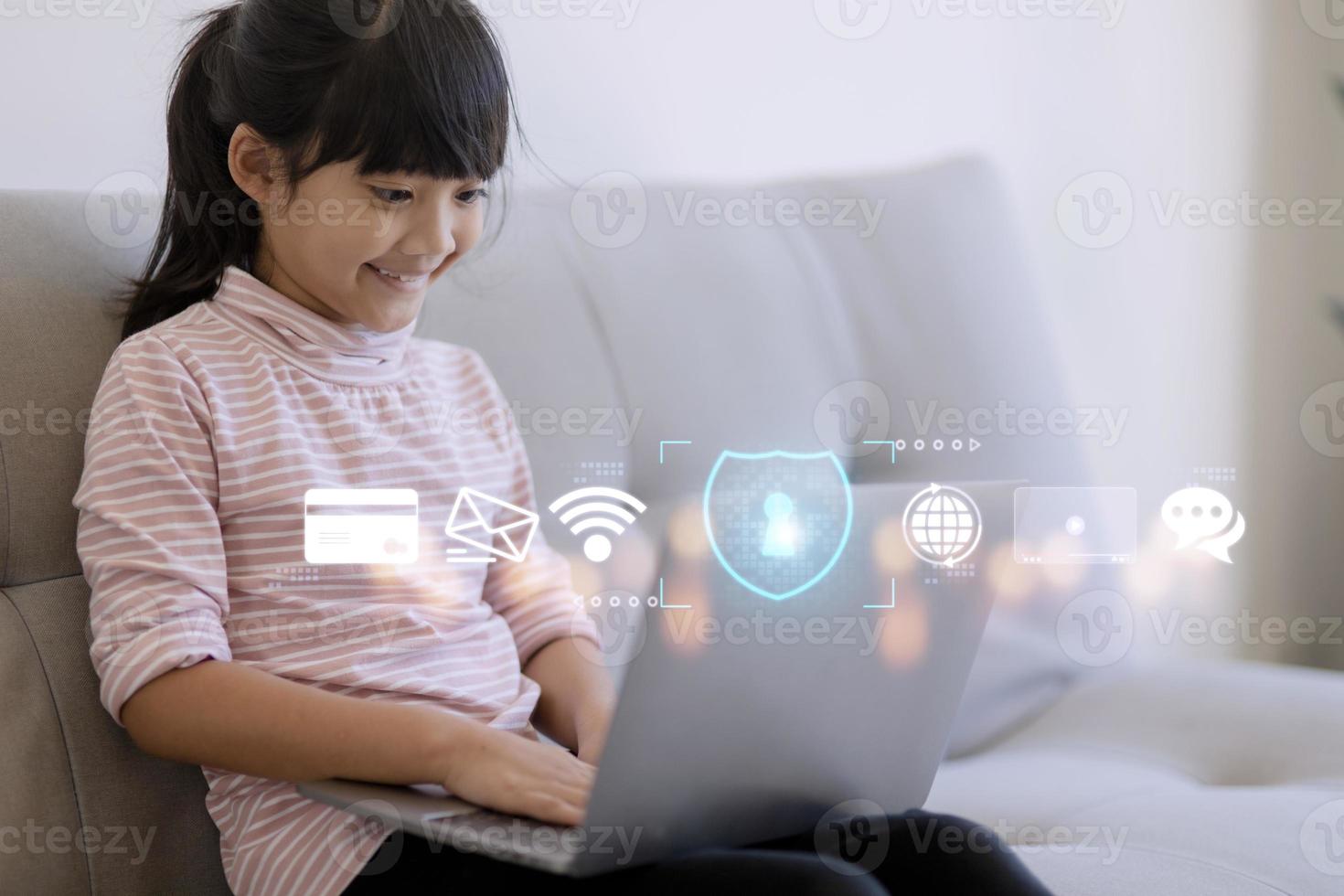 Child safety online. Little girl using laptop at home. icon of
