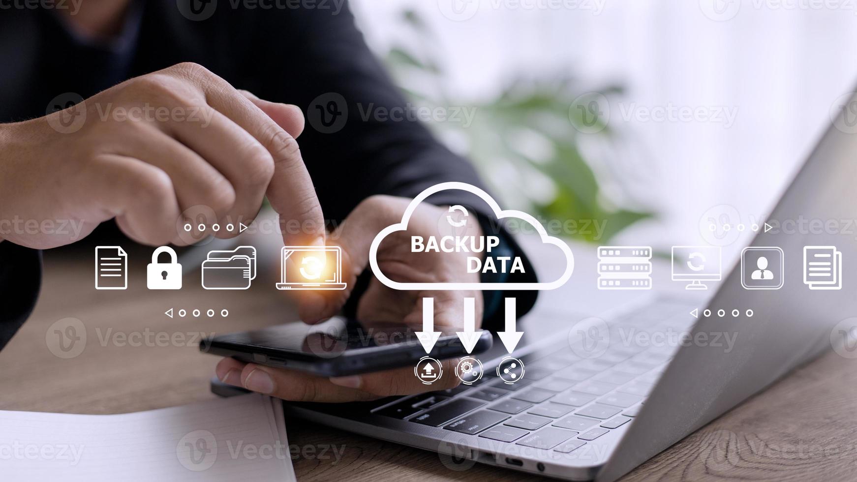 Businessman using a computer to backup storage data Internet technology concept for backup online documentation database and digital file storage system or software,file access, doc sharing. photo