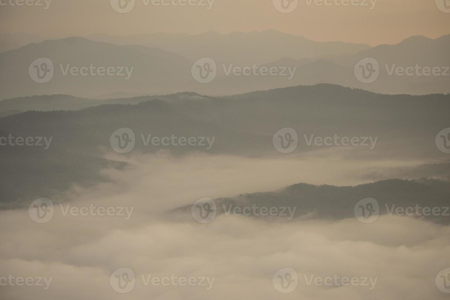 Layer of mountains and mist during sunset photo